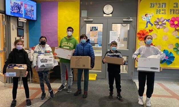 Akiva School students help fill the MADA pantry for Passover.